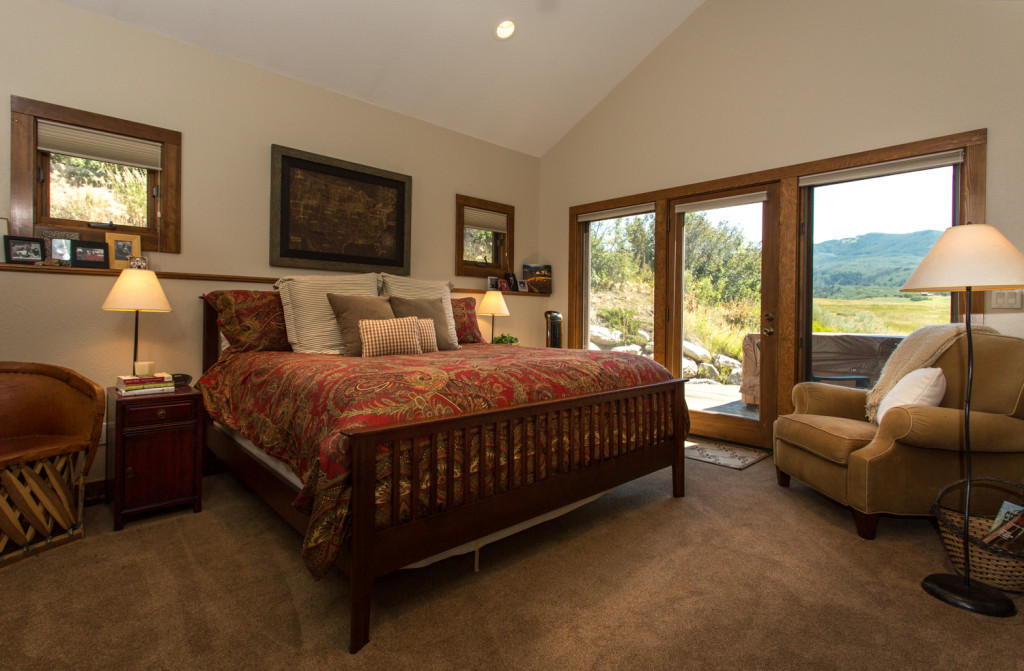 Master suite with hot tub on private deck overlooking open meadow.