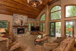 River rock fireplace, tongue and groove ceiling and decks all around.